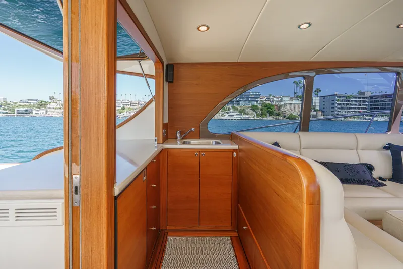 Slide: The Image of Luxurious 2019 Palm Beach Motor Yachts Express interior with wood finish and waterfront view. - 13
