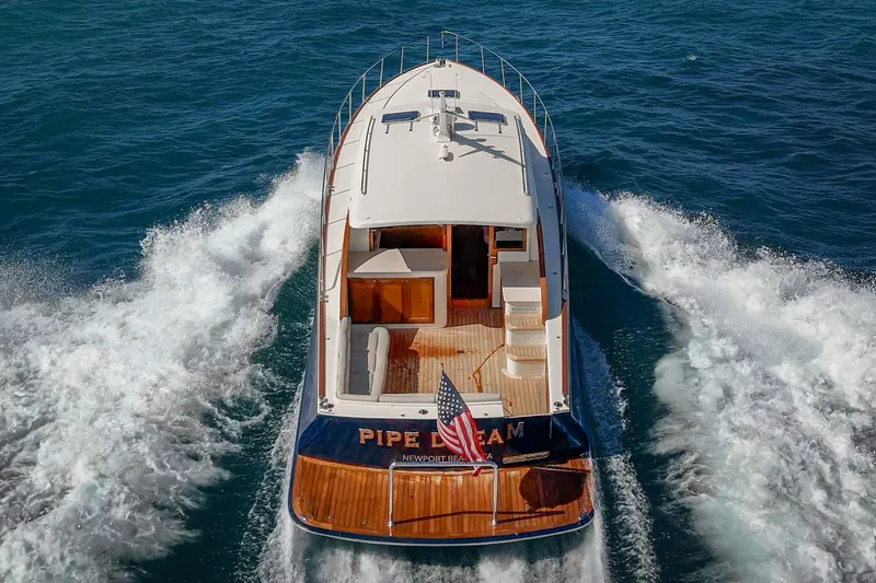 Slide: The Image of 2019 Palm Beach Motor Yachts Express cruising on open water, rear view. - 37
