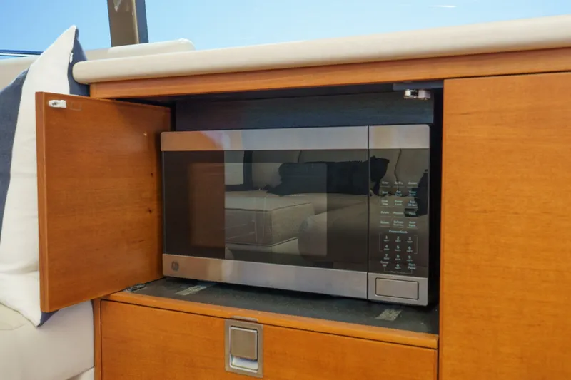 Slide: The Image of Built-in microwave in 2019 Palm Beach Motor Yachts Express, wooden cabinetry. - 17