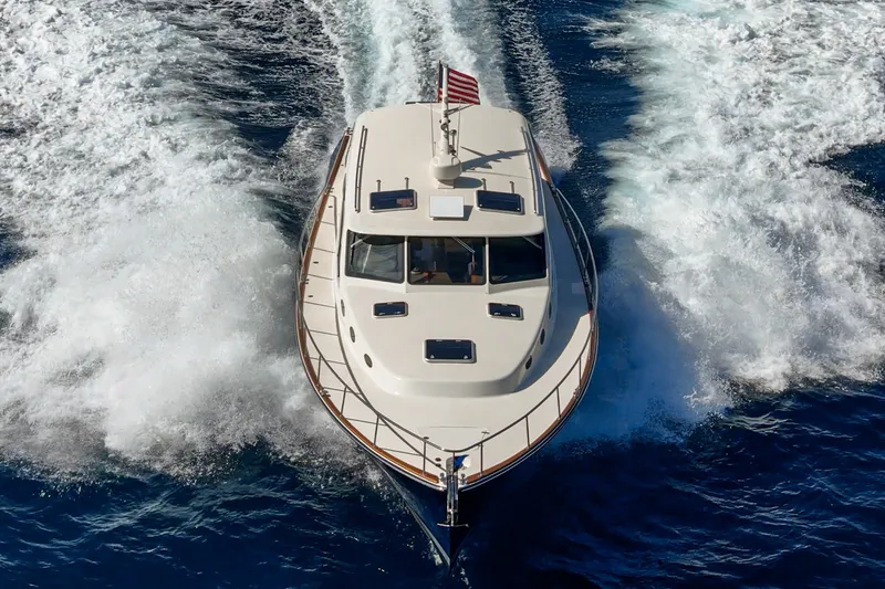 Slide: The Image of 2019 Palm Beach Motor Yachts Express cruising on open water, aerial view. - 49