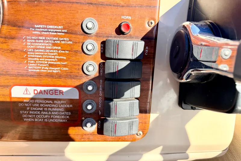 Slide: The Image of Control panel of a 2000 Harris-Kayot Classic 220 O/B boat with safety checklist and switches. - 64