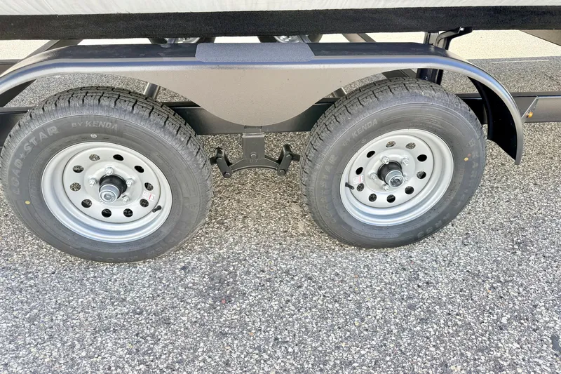Slide: The Image of Trailer wheels of a 2000 Harris-Kayot Classic 220 O/B on asphalt. - 77
