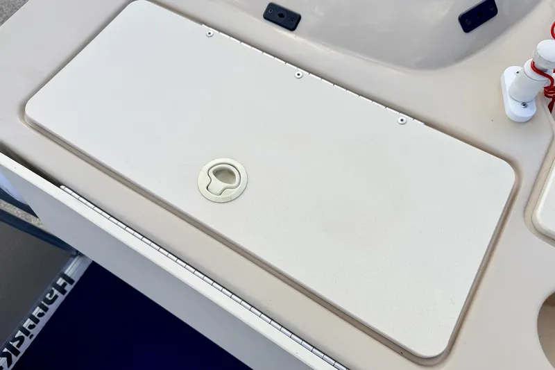 Slide: The Image of Harris-Kayot Classic 220 O/B 2000 boat deck with storage compartment and latch. - 33