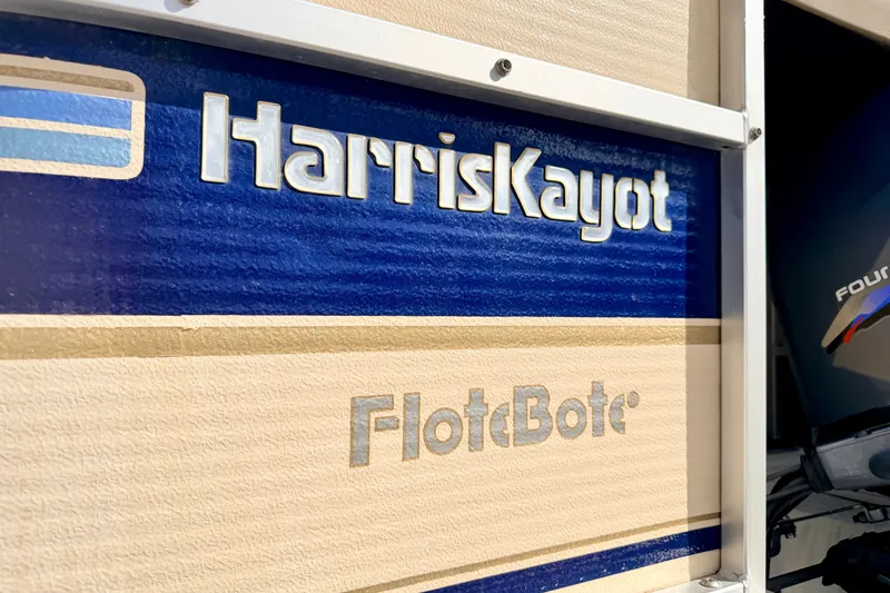 Slide: The Image of Harris-Kayot Classic 220 O/B 2000 boat logo with blue and beige design. - 20