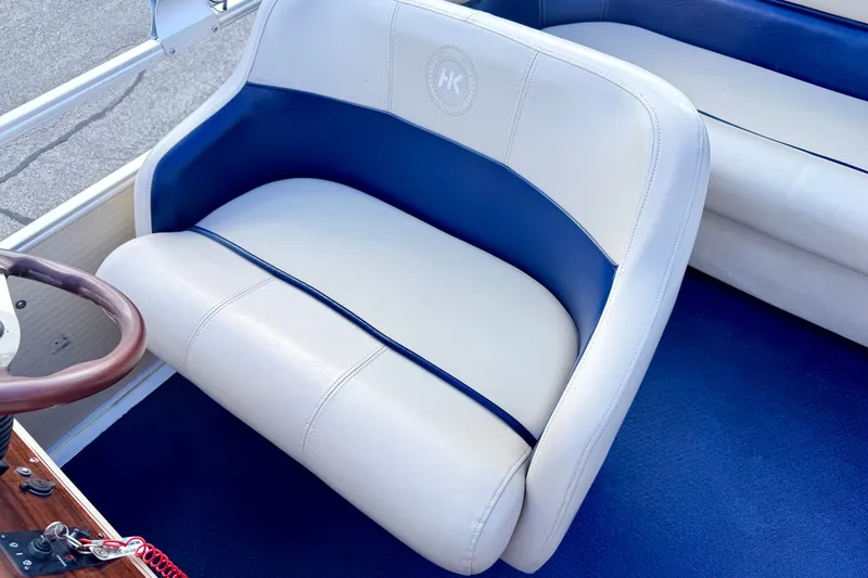 Slide: The Image of 2000 Harris-Kayot Classic 220 O/B boat interior with blue and white seating. - 53
