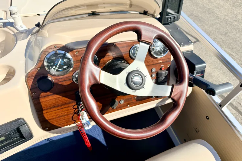 Slide: The Image of Steering wheel and dashboard of 2000 Harris-Kayot Classic 220 O/B boat. - 58