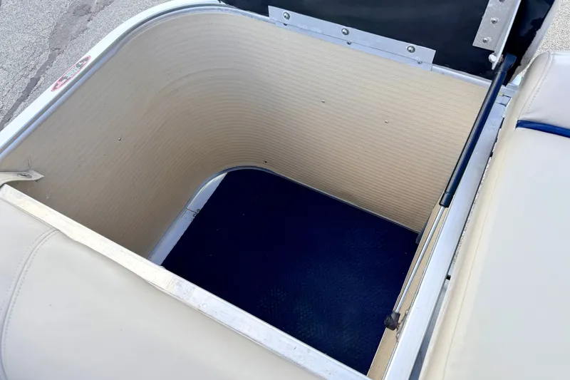 Slide: The Image of Storage compartment of a 2000 Harris-Kayot Classic 220 O/B boat, featuring beige interior. - 42