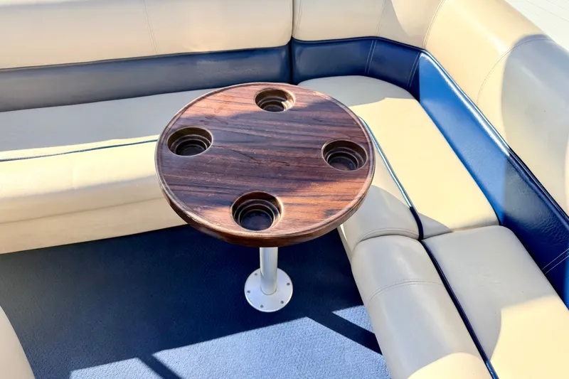 Slide: The Image of Interior of 2000 Harris-Kayot Classic 220 O/B with round wooden table and cushioned seating. - 55