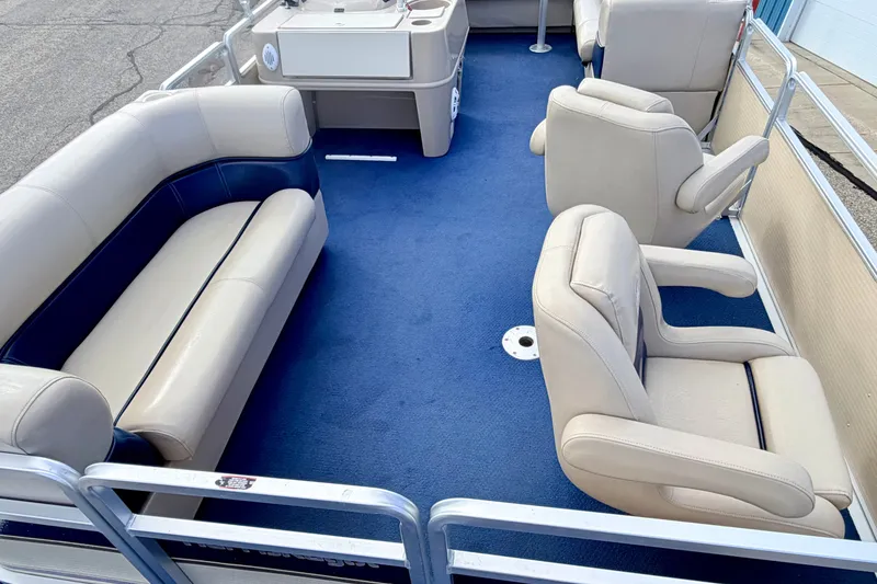 Slide: The Image of 2000 Harris-Kayot Classic 220 O/B pontoon boat interior with blue carpet and beige seating. - 23