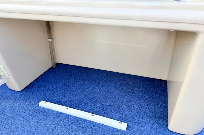 Slide: The Image of 2000 Harris-Kayot Classic 220 O/B boat interior with blue carpet and beige paneling. - 32
