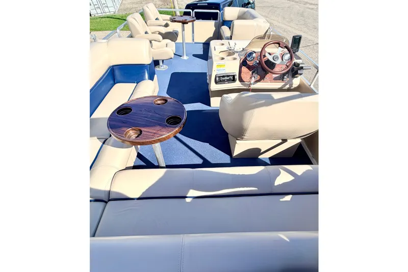Slide: The Image of 2000 Harris-Kayot Classic 220 O/B pontoon boat interior with beige seating and wooden table. - 69