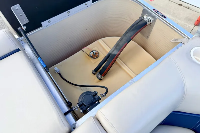 Slide: The Image of Open storage compartment in a 2000 Harris-Kayot Classic 220 O/B boat, showing internal components. - 44