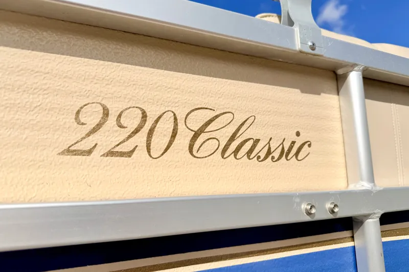 Slide: The Image of 2000 Harris-Kayot Classic 220 O/B boat with beige and blue detailing. - 14