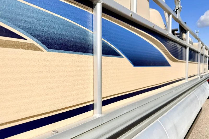 Slide: The Image of 2000 Harris-Kayot Classic 220 O/B pontoon boat with blue and beige design. - 15