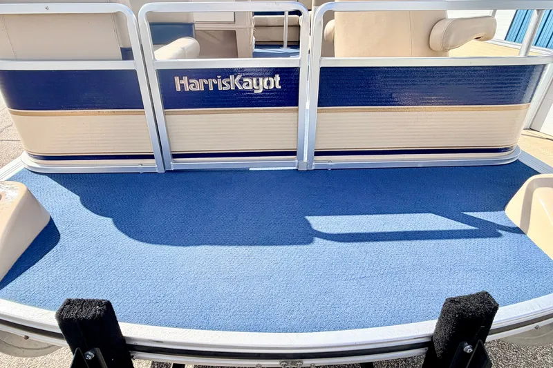 Slide: The Image of 2000 Harris-Kayot Classic 220 O/B pontoon boat with blue carpet and seating area. - 22
