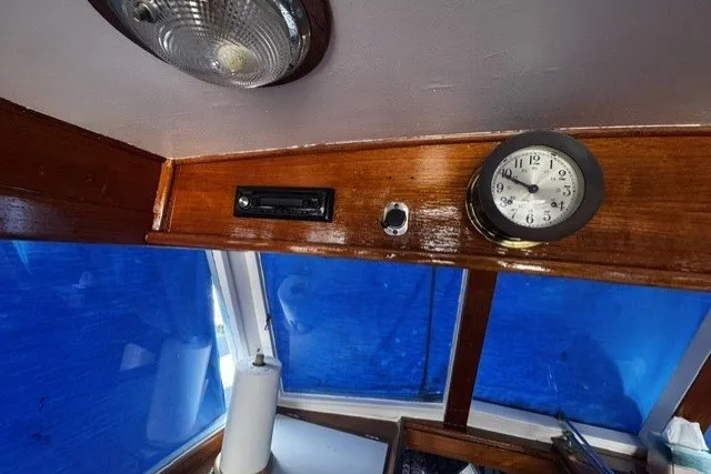 Slide: The Image of Interior of a 1974 Grand Banks 32 Sedan with clock and wooden paneling. - 8
