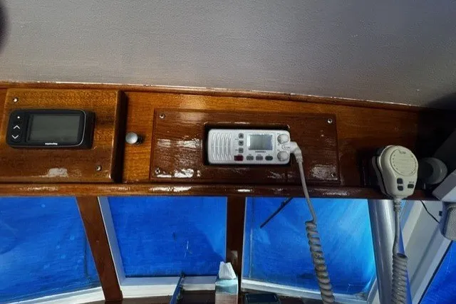Slide: The Image of 1974 Grand Banks 32 Sedan interior with navigation equipment and radio controls. - 7