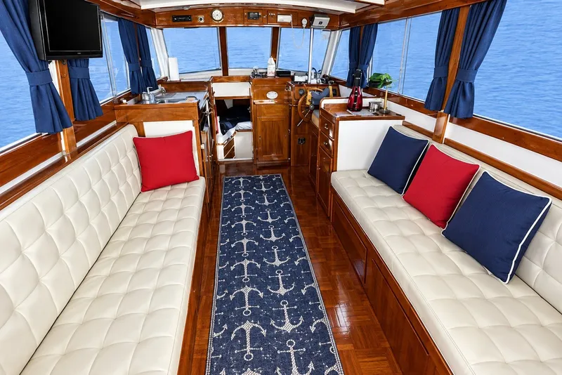 Slide: The Image of Interior of a 1974 Grand Banks 32 Sedan with nautical decor and plush seating. - 13