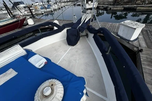 Slide: The Image of 1974 Grand Banks 32 Sedan boat docked at marina with blue covers. - 4