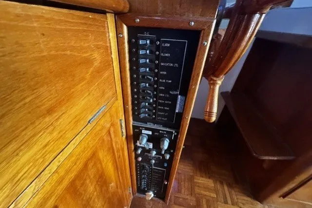 Slide: The Image of Electrical panel of a 1974 Grand Banks 32 Sedan boat with wooden interior. - 14