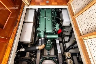 Slide: The Image of Engine compartment of a 1974 Grand Banks 32 Sedan, showcasing a well-maintained marine engine. - 18