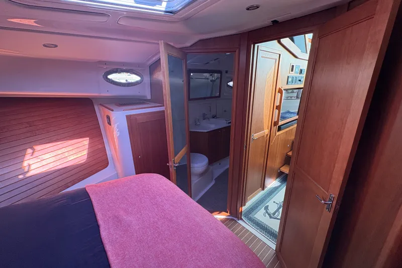 Slide: The Image of Luxurious interior of 2025 Back Cove 39O yacht featuring bedroom and bathroom. - 10