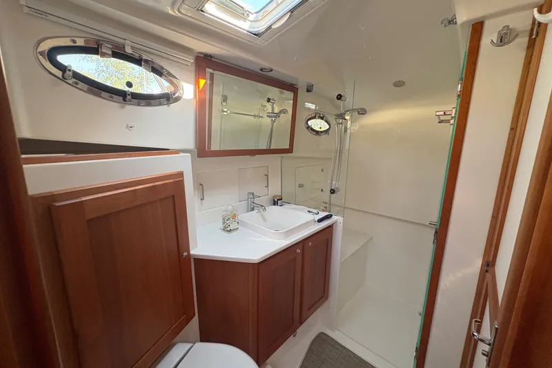 Slide: The Image of Luxurious bathroom in 2025 Back Cove 39O yacht with modern fixtures and wood accents. - 16