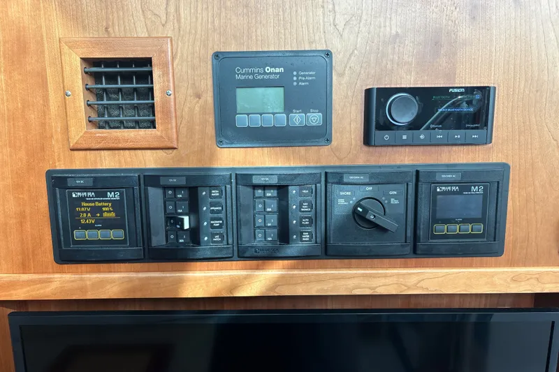 Slide: The Image of Control panel of a 2025 Back Cove 39O boat with marine generator and audio system. - 43