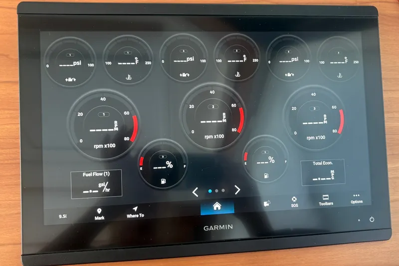 Slide: The Image of Garmin display showing engine metrics on 2025 Back Cove 39O boat dashboard. - 38