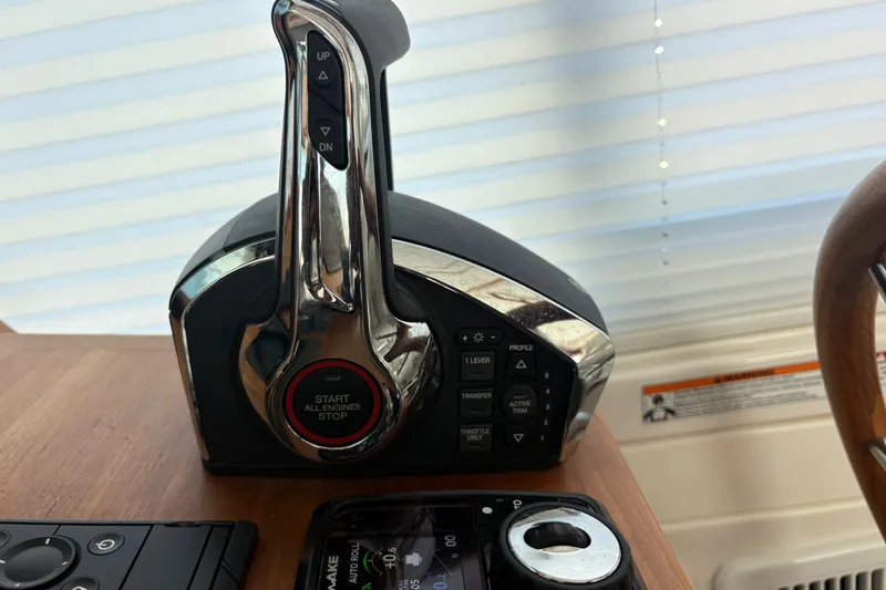 Slide: The Image of Throttle control panel of 2025 Back Cove 39O boat, featuring engine start and stop buttons. - 31