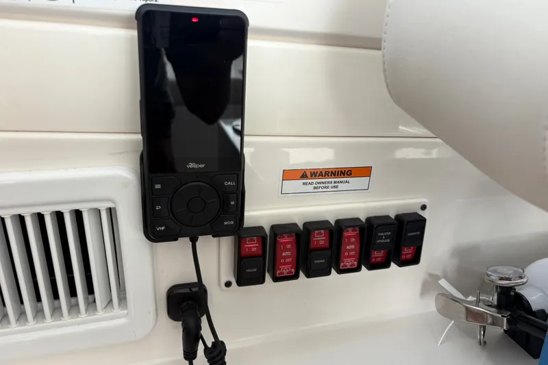 Slide: The Image of Control panel of 2025 Back Cove 39O boat with VHF radio and switches. - 32