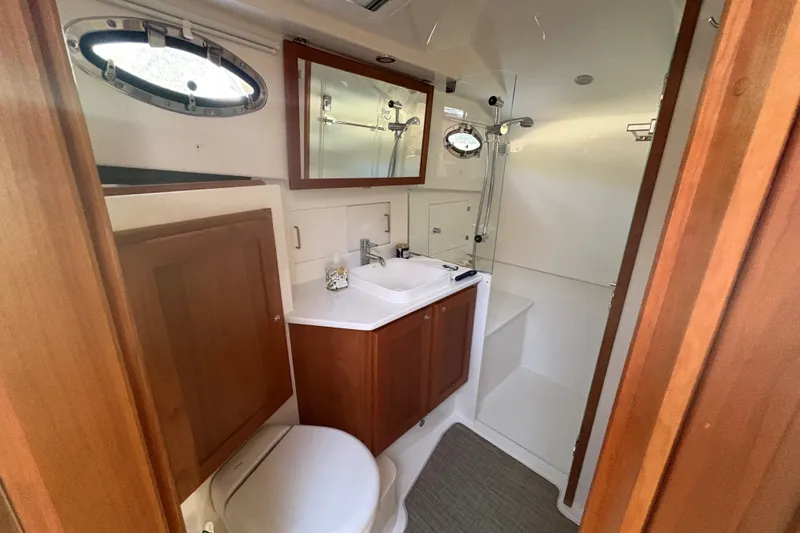 Slide: The Image of Luxurious bathroom in 2025 Back Cove 39O yacht with modern fixtures and wooden cabinetry. - 12