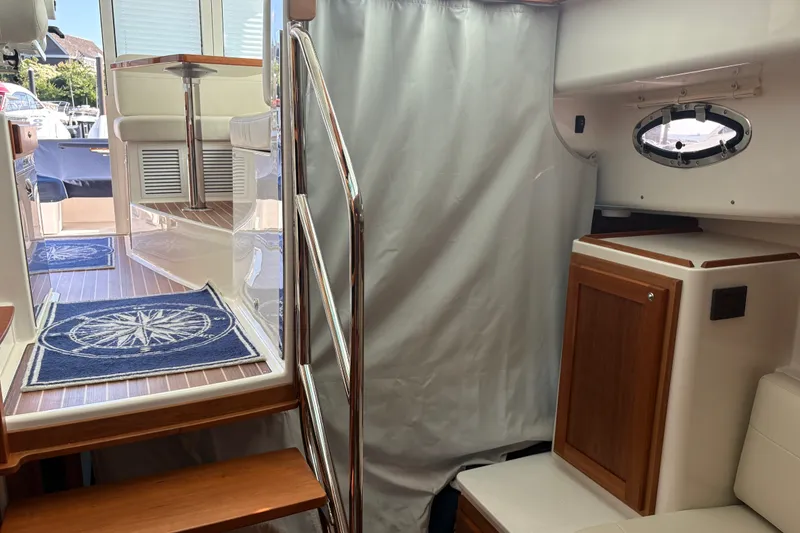 Slide: The Image of Interior view of 2025 Back Cove 39O yacht, featuring stairs and nautical decor. - 19
