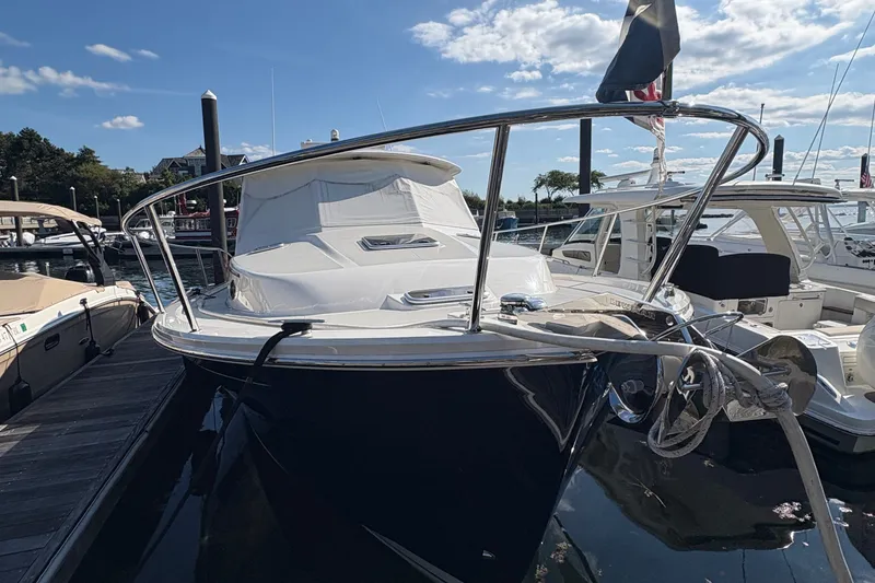 Slide: The Image of 2025 Back Cove 39O yacht docked at marina under blue sky. - 2