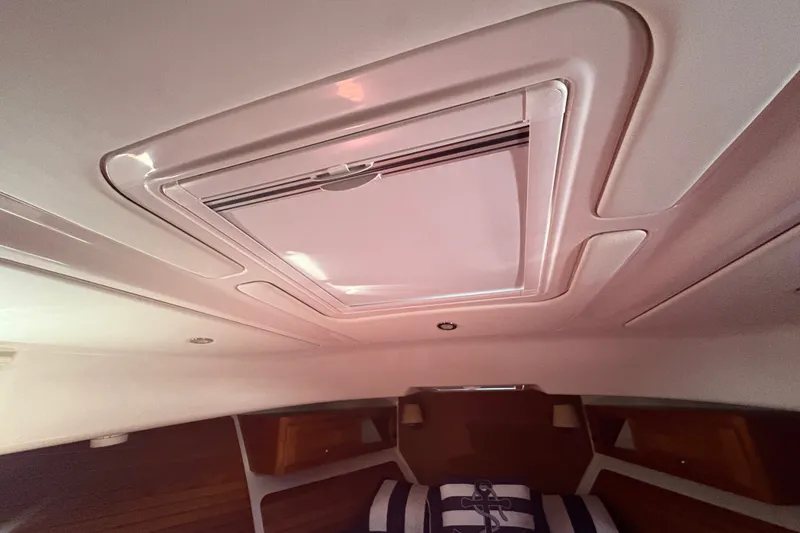 Slide: The Image of Interior cabin view of 2025 Back Cove 39O yacht with ceiling hatch. - 7