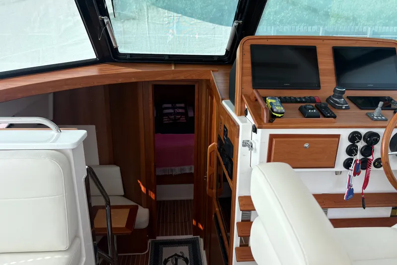 Slide: The Image of Interior of 2025 Back Cove 39O boat with helm, seating, and cabin entrance. - 20