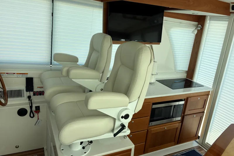 Slide: The Image of Interior of 2025 Back Cove 39O yacht with helm chairs and modern kitchen amenities. - 23