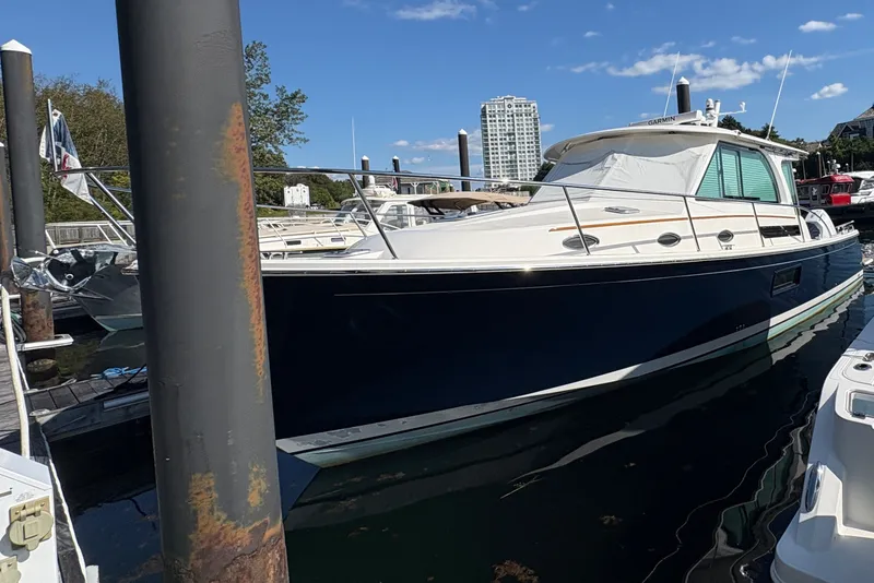Slide: The Image of 2025 Back Cove 39O yacht docked at marina under clear blue sky. - 0