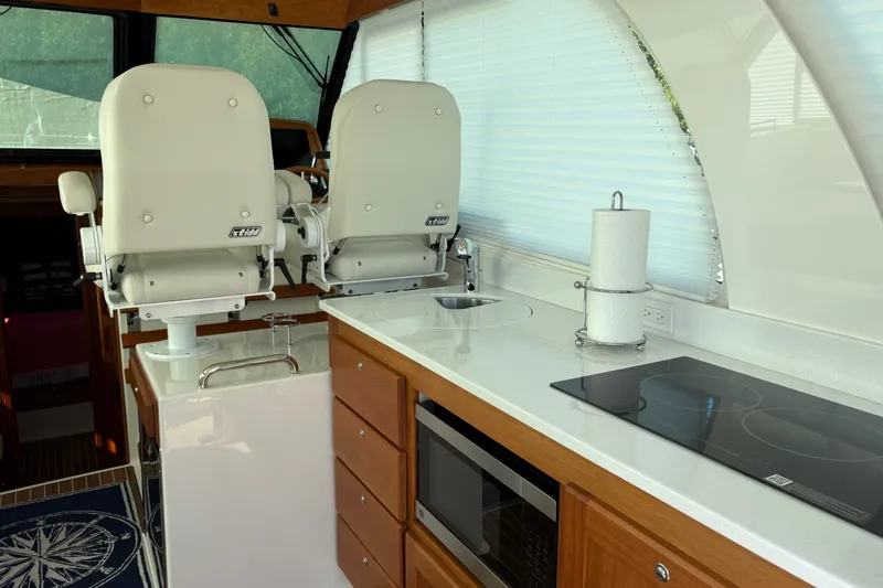 Slide: The Image of Luxurious interior of 2025 Back Cove 39O yacht with modern kitchen and seating. - 25