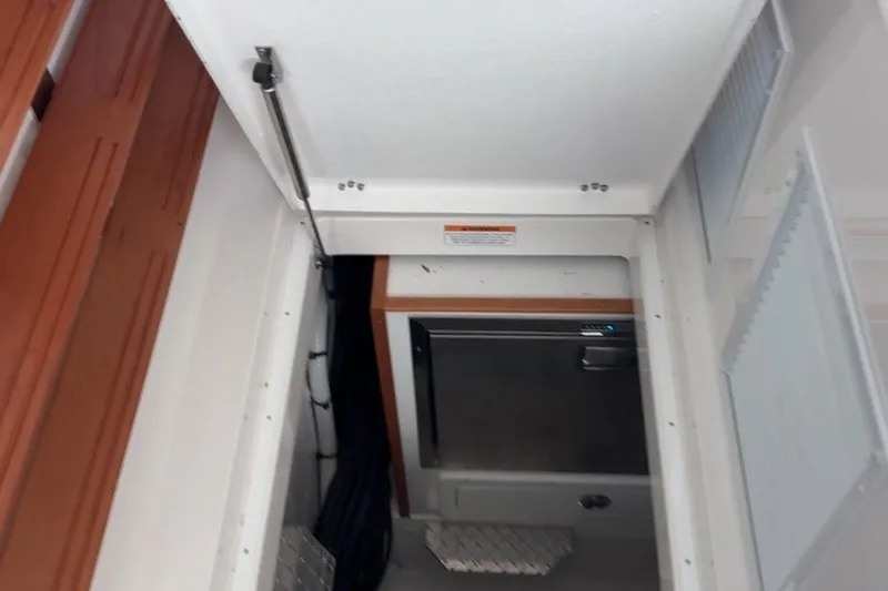 Slide: The Image of 2025 Back Cove 39O interior hatch with storage compartment and metal steps. - 40