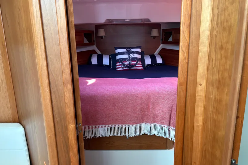 Slide: The Image of Cozy cabin interior of 2025 Back Cove 39O with nautical-themed bedding. - 4