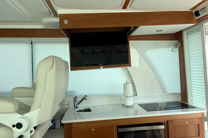 Slide: The Image of Interior of 2025 Back Cove 39O yacht with modern kitchen and seating area. - 24