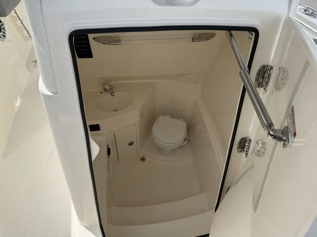 Slide: The Image of The image shows the interior of a boat bathroom with a toilet and sink. - 29