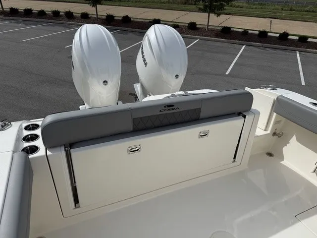 Slide: The Image of The image shows the stern of a 2024 Cobia 280 Center Console boat with two outboard engines. - 10