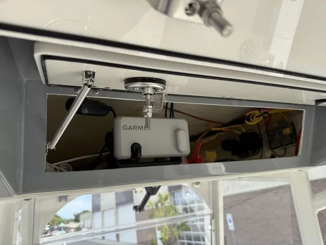 Slide: The Image of A Garmin device is mounted in a compartment of a 2024 Cobia 280 Center Console boat. - 25