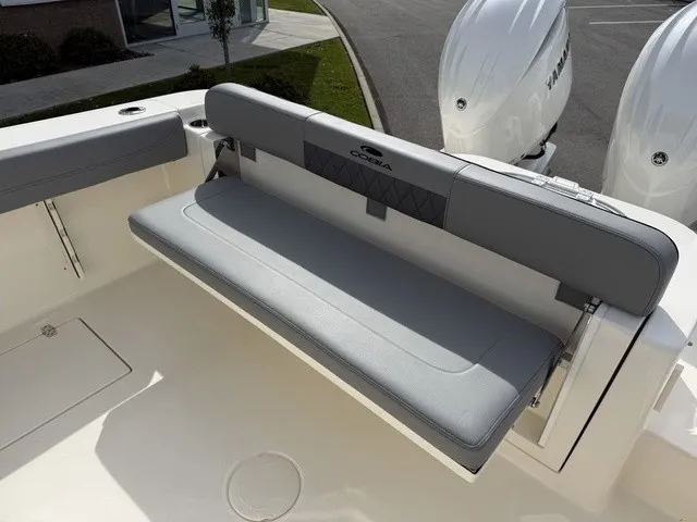 Slide: The Image of The 2024 Cobia 280 Center Console features a gray fold-down bench seat at the stern. - 8
