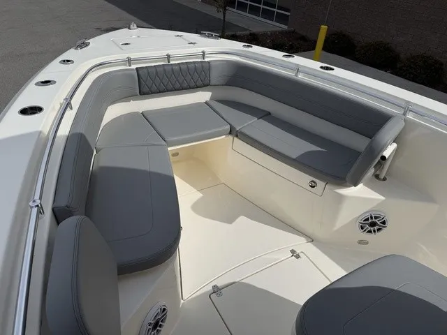 Slide: The Image of Cobia 280 Center Console 2024: Spacious bow area with gray cushions and speakers. - 31
