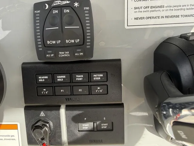 Slide: The Image of Close-up of the control console with Yamaha controls and trim tab adjustment. - 21