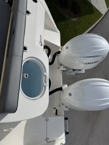 Slide: The Image of The image shows the stern of a Cobia 280 Center Console boat with two Yamaha outboard engines. - 7