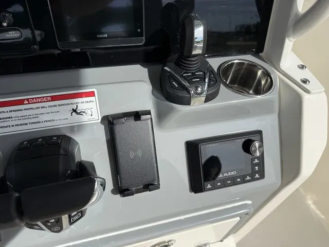 Slide: The Image of The image shows the helm of a Cobia 280 Center Console boat with modern controls. - 22